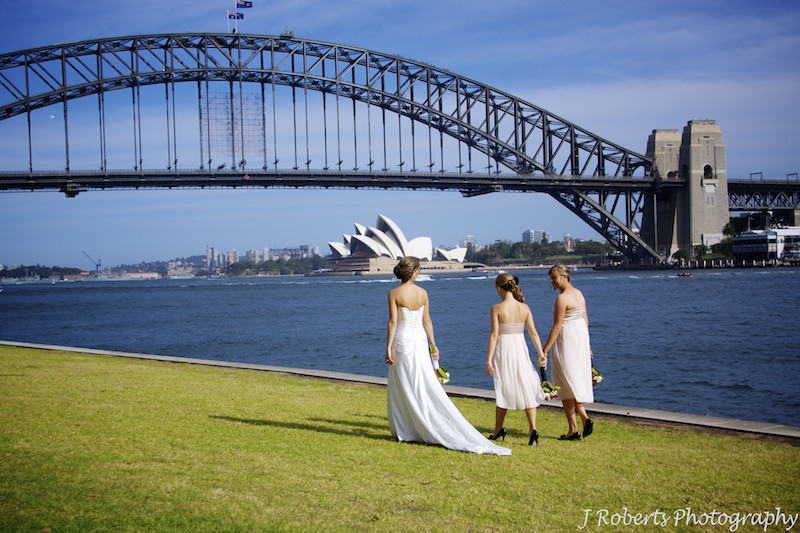 Bride and bridesmaids walking under Sydney harbour bridge - wedding photography